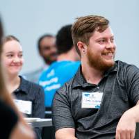 Students smile as they watch the presentation